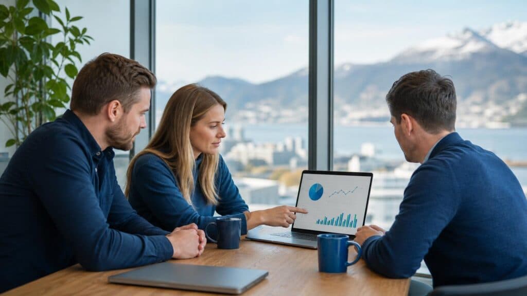 Tre profesjonelle markedsførere analyserer SEO- og konverteringsdata på laptop i moderne kontormiljø med utsikt, fokus på datadrevet vekststrategi
